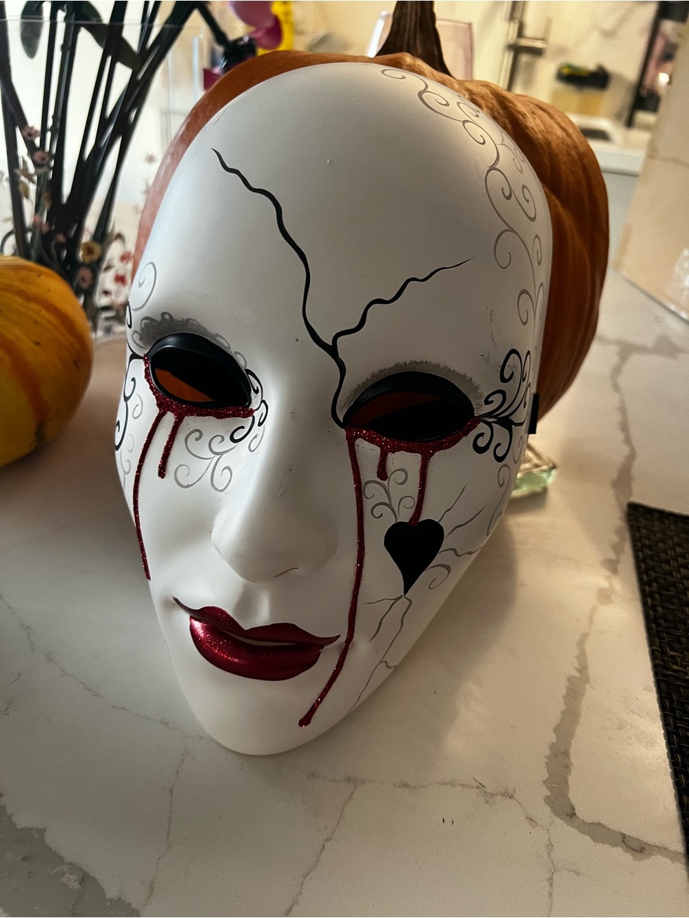White Decorative Face Mask with Red Accents and Black Detailing